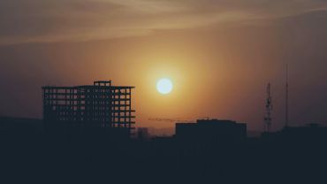 Sunset over a building under construction