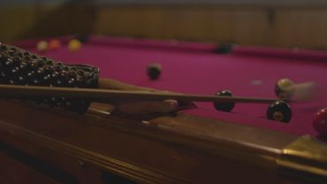 Punk person playing pool