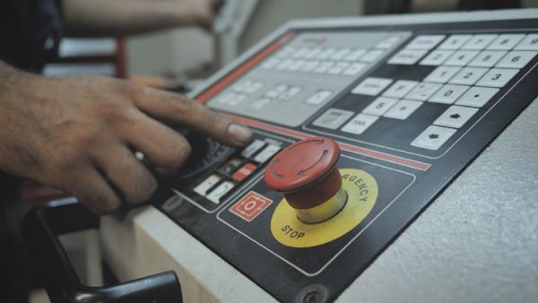 Worker operating an industrial lathe