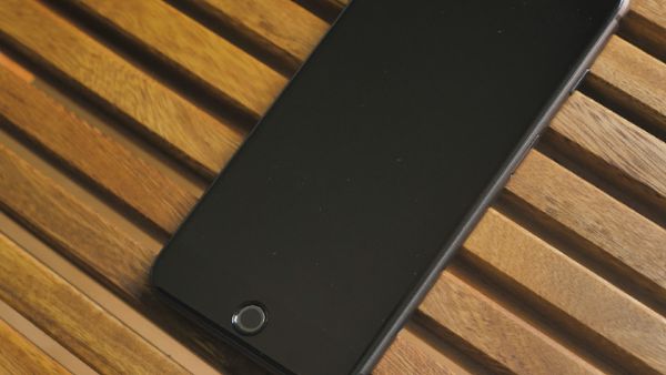 Black cellphone on a wooden table