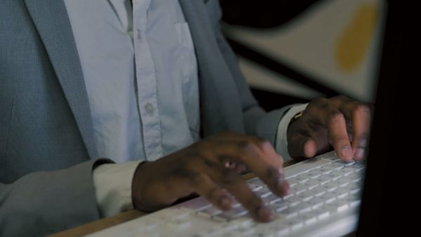 A person typing on a keyboard