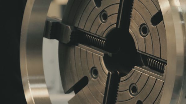 Engineer Measuring a Lathe