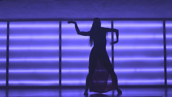 Contemporary dancer in neon-lit studio