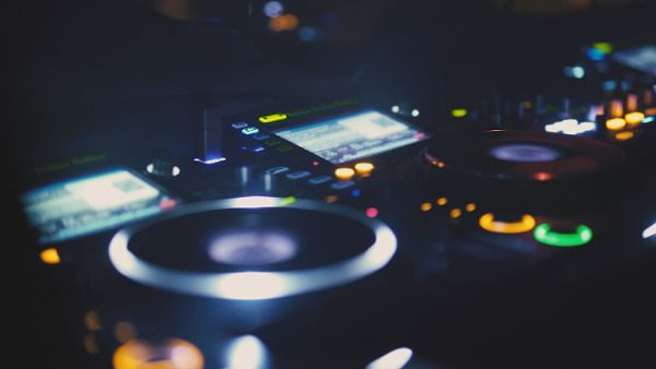Close up of a DJ playing music at nightclub
