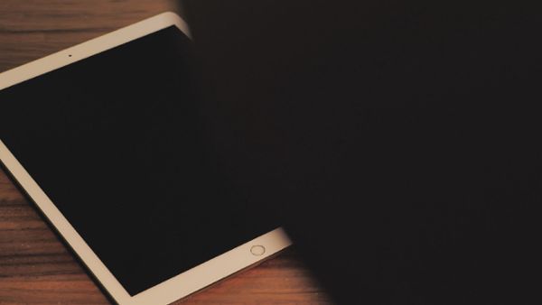 White tablet on a wooden table