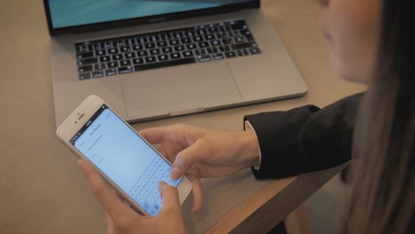 A woman writing an email on her smartphone