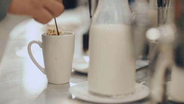 Woman preparing a cup of warm tea with tea bag